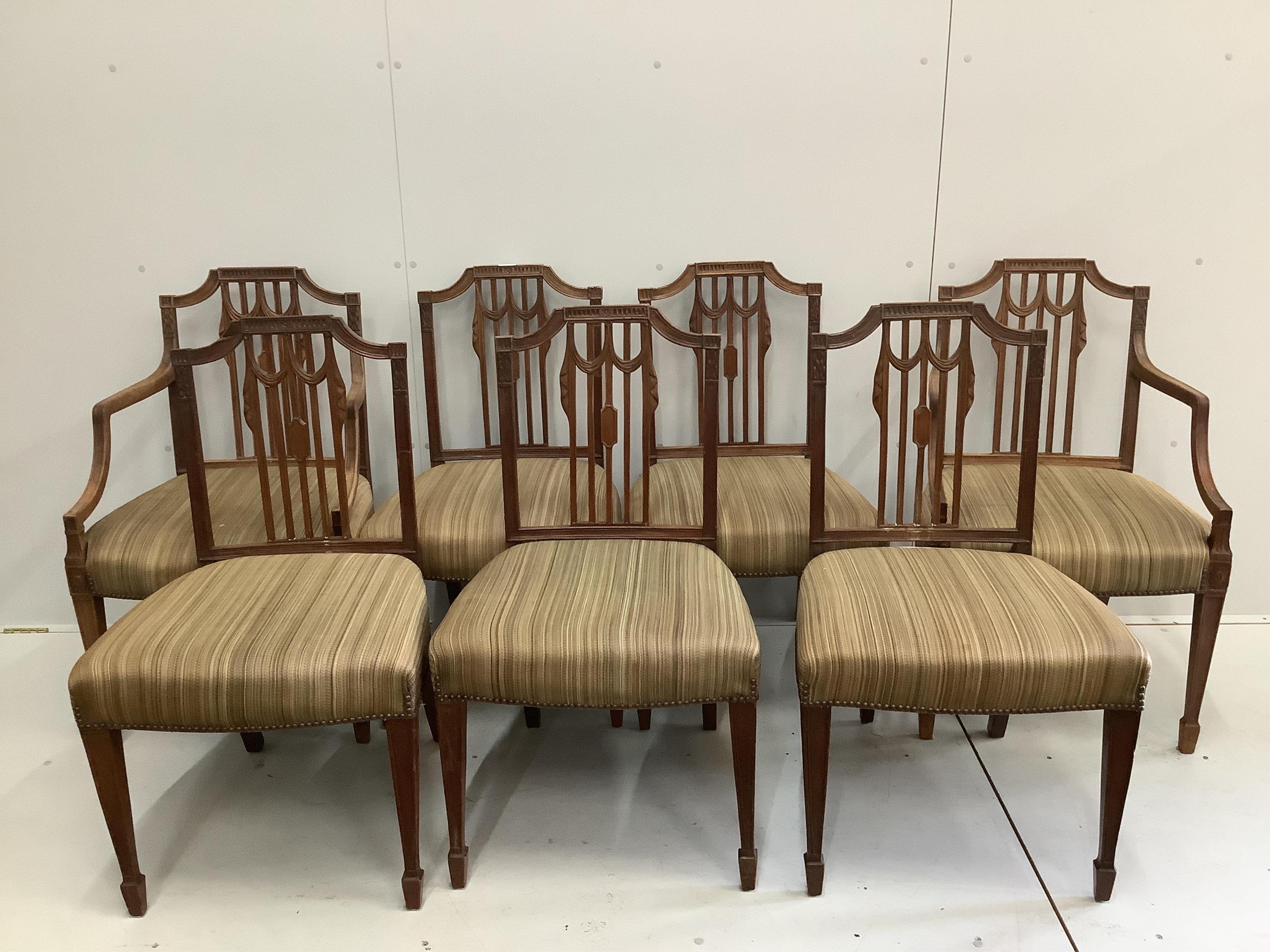 A set of seven Sheraton style mahogany dining chairs, two with arms, width 56cm, depth 50cm, height 91cm. Condition - fair